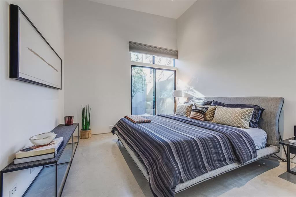 The master bedroom (one of two bedrooms in the home) leads to a courtyard deck. 