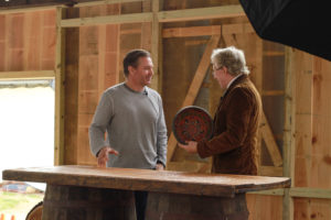 PaperCity's Chad Miller receives a short history of his family's Norwegian painted bowl from 1857. (Photo by Chris P. Bachman)