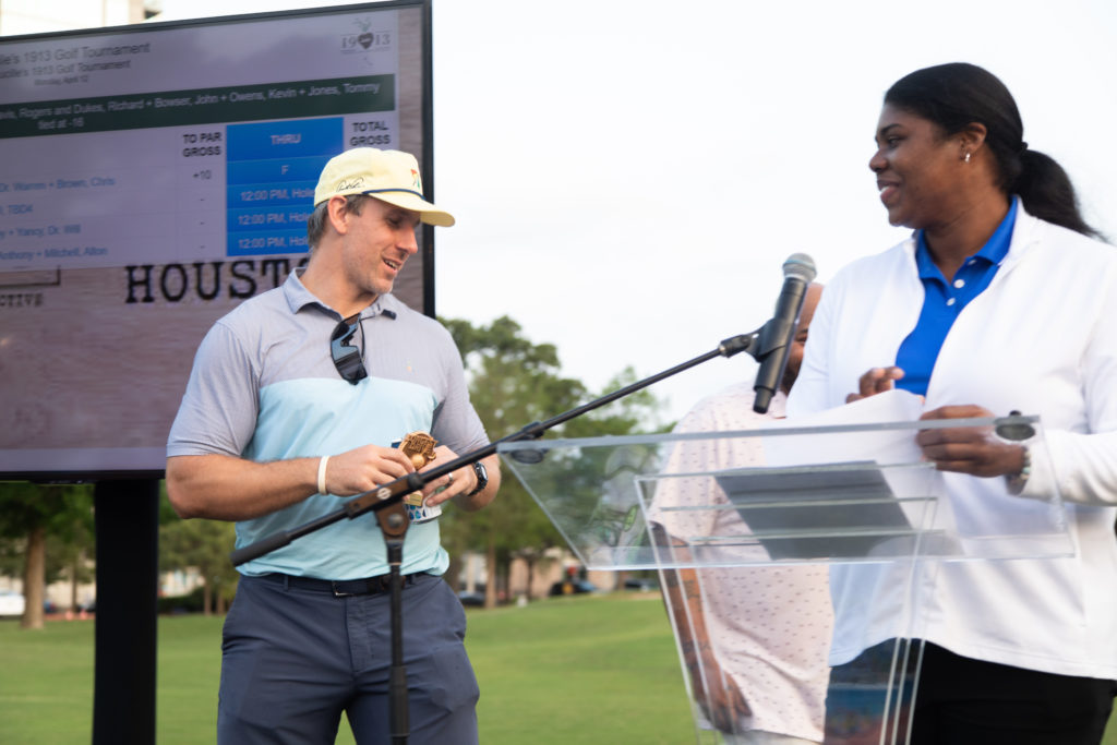 Former Houston Texans star Owen Daniels wins the Lucille's 1913 golf tournament long drive competition, the award presented by Maulana Dotch, Hermann Park golf director. (Photo by Leah Wilson)
