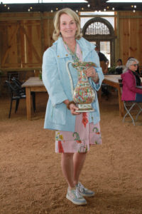 Melinda Abell holds a family treasure: a Rose Famille Chinese porcelain. (Photo by Chris P. Bachman)