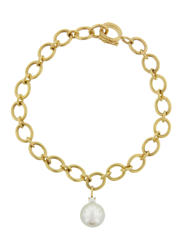 Pearl charm and yellow gold link bracelet designed by Irene Neuwirth.