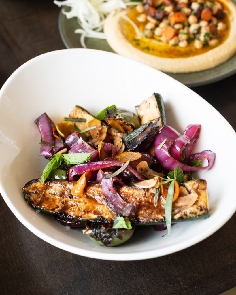 The first course: a crispy squash blossom, lady peas, and pickled shallot. (courtesy of Collective Retreats)