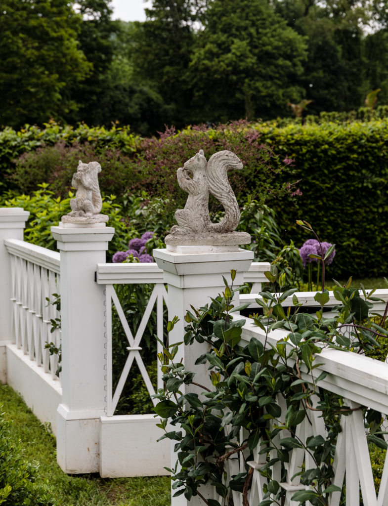 Antique concrete squirrels at the entrance to the dovecote