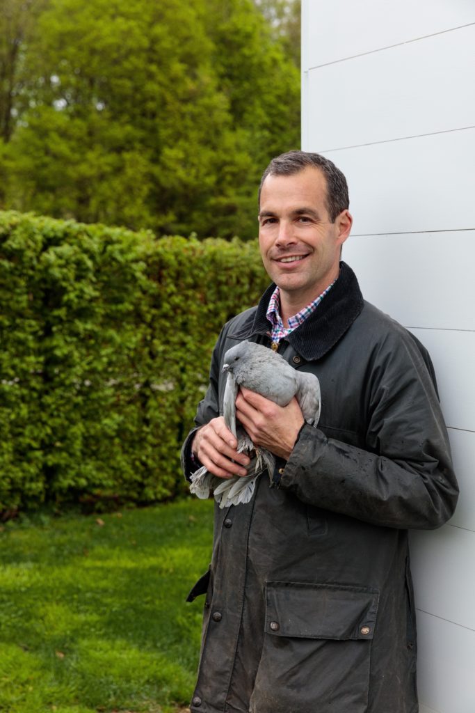 Christopher Spitzmiller at Clove Brook Farm with a Blue Indian fantail pigeon