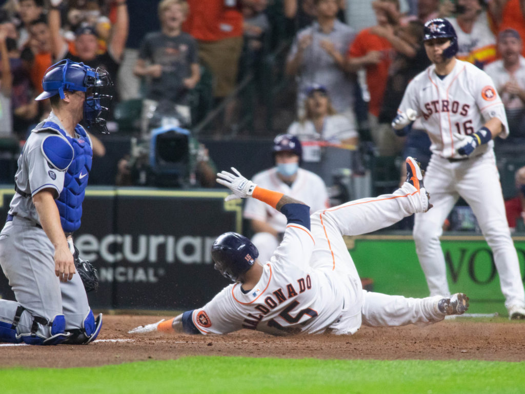 Astros catcher Martin Maldonado slide in. (Photo by F. Carter Smith)