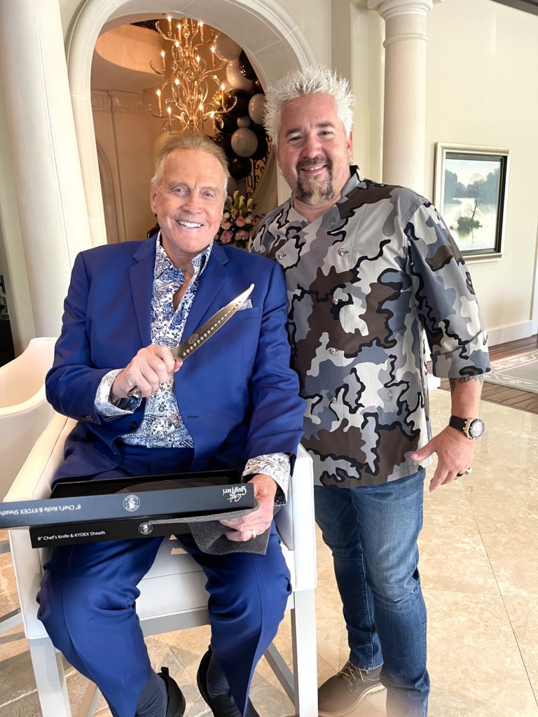Food Network chef Guy Fieri presents  Lee Majors (aka the Six Million Dollar Man) with an engraved knife at the film star's 82nd birthday dinner.
