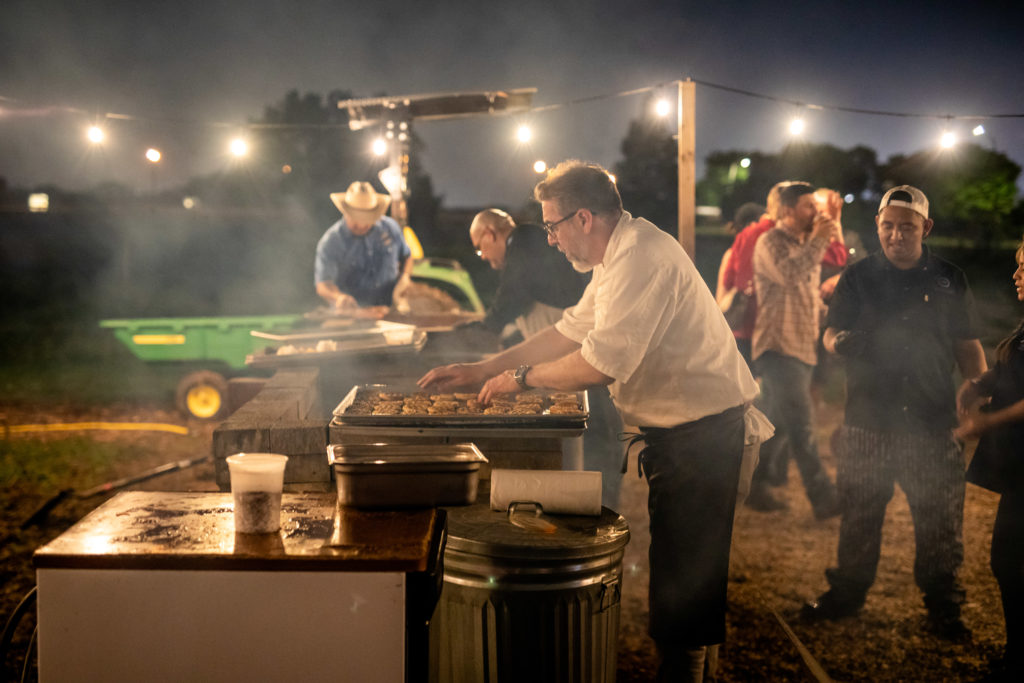 Chefs cooking over live fire for Recipe for Success' Delicious Alchemy dinner. (Photo by Kirsten Gilliam)