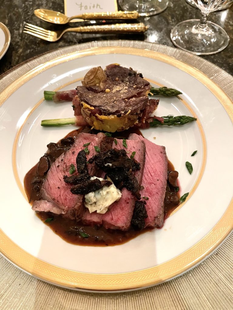 Sliced Tomahawk Ribeye, topped with morel mushrooms, was centerpiece of Guy Fieri's six-course meal served for Lee Majors' birthday.