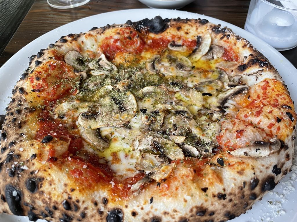 The Brooklyn pizza: shaved mushrooms, Parmigiana, red pepper flakes, and oregano.