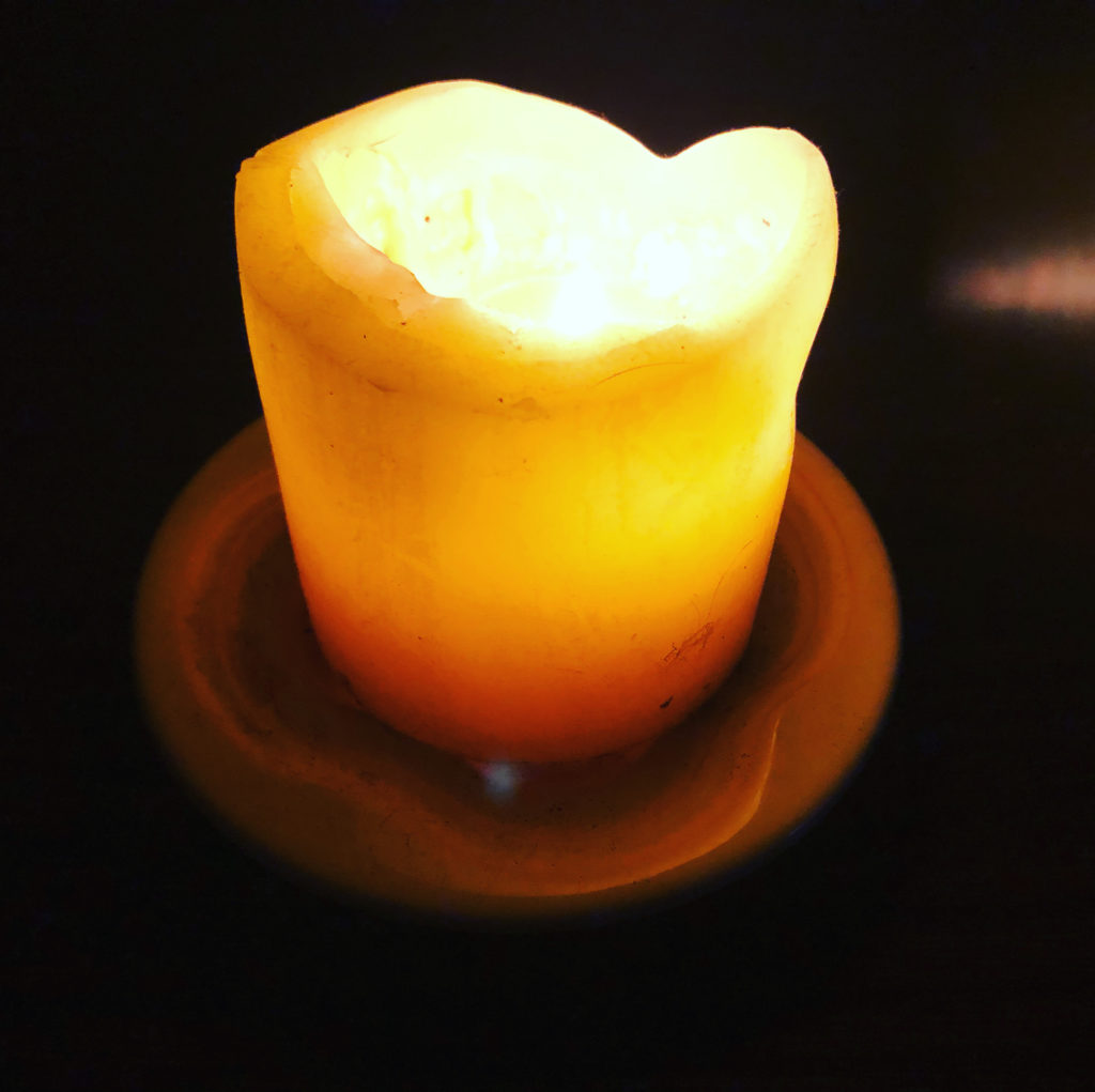 Sarah Gish lights a candle nightly to remember the COVID victims.