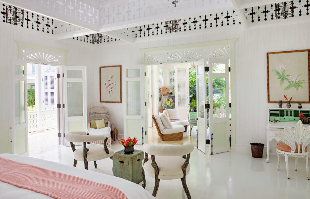 A guest house room where light pours in through five sets of shuttered doors and the tragaluz fretwork.
