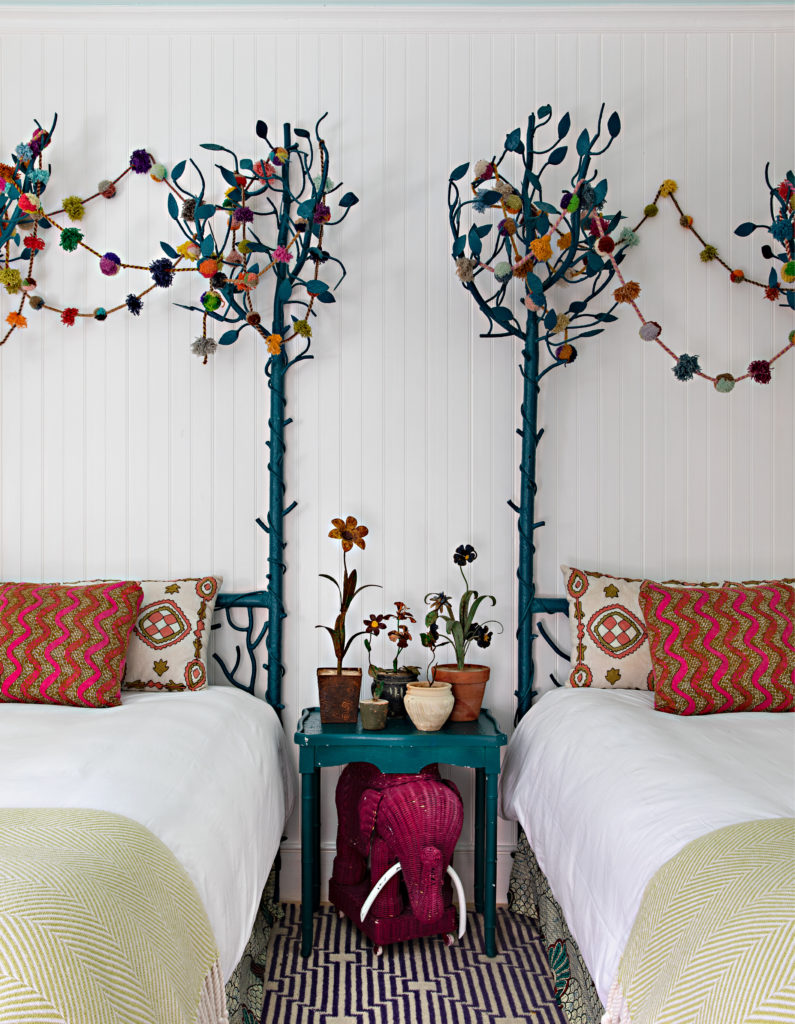 A guest bedroom with fanciful iron work.