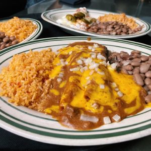 The Original – cheese enchiladas con carne topped with raw onion