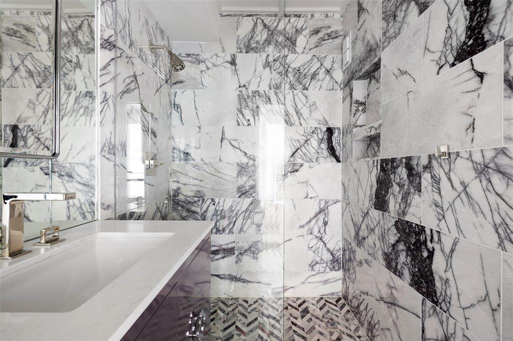 The shower in the 16th floor condo at 1400 Hermann is clad in Milas lilac honed marble.