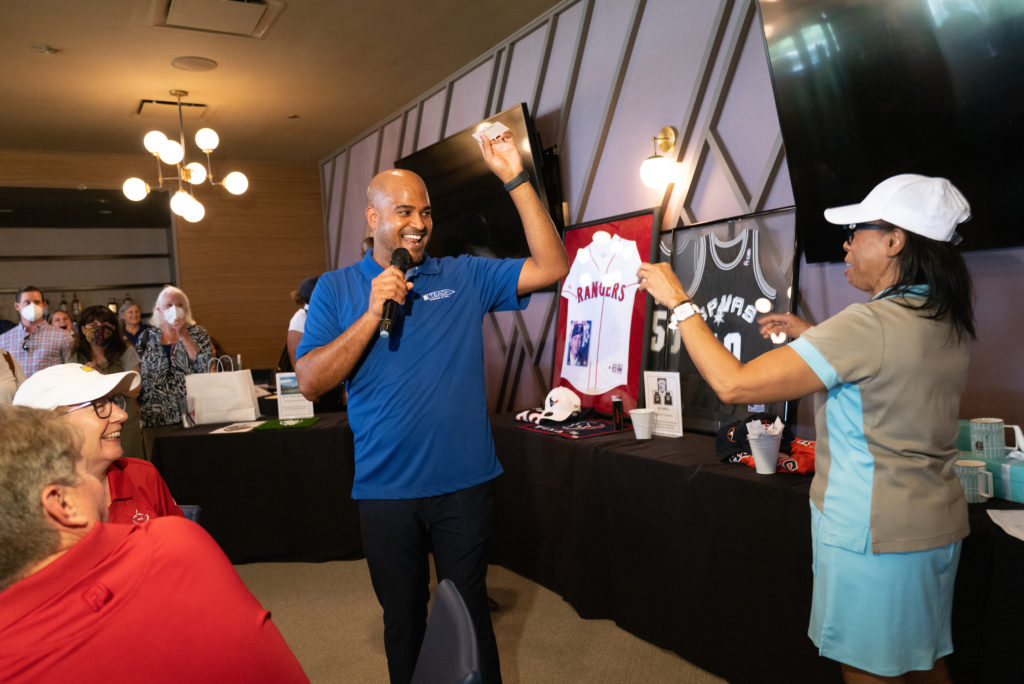 TEACH executive Alvin Abraham announces winners of the Tee Off Fore TEACH competition at Topgolf Katy.