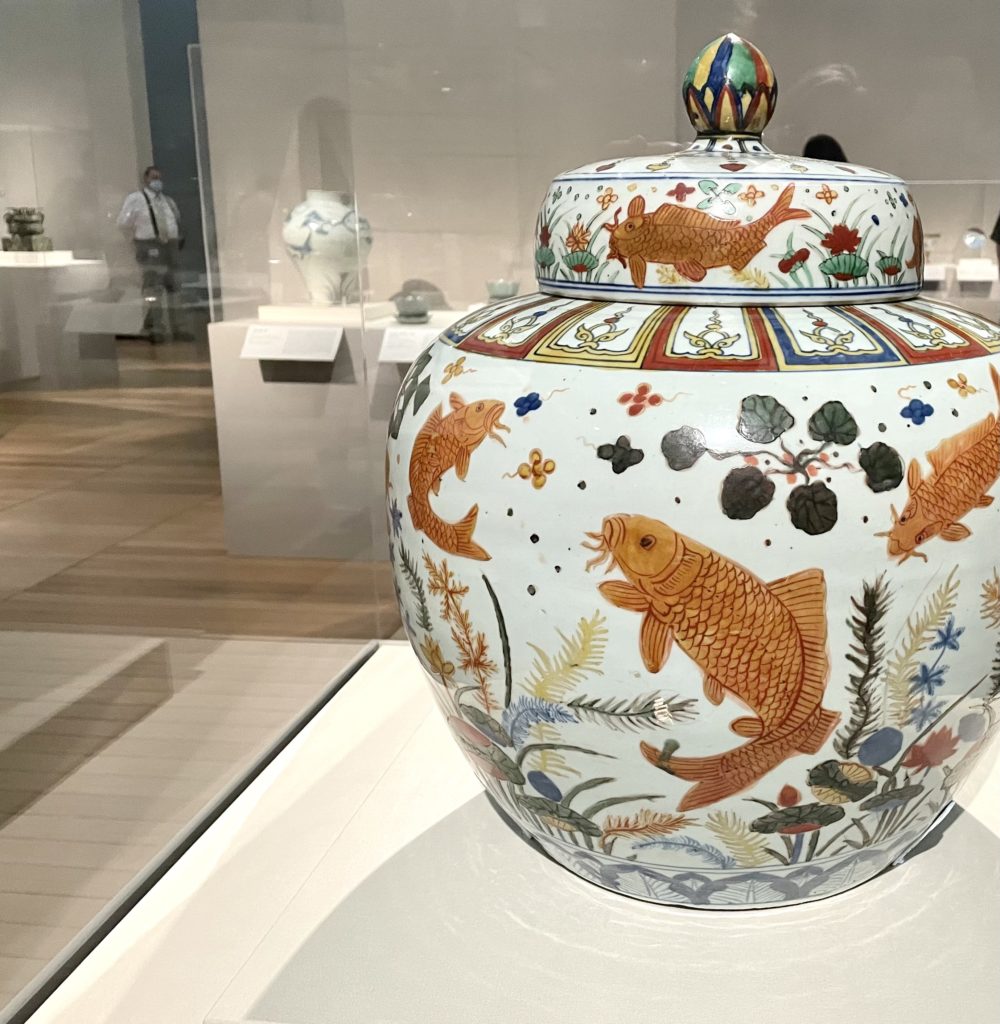 Koi swim across a lidded pot. (Photo by Courtney Dabney).