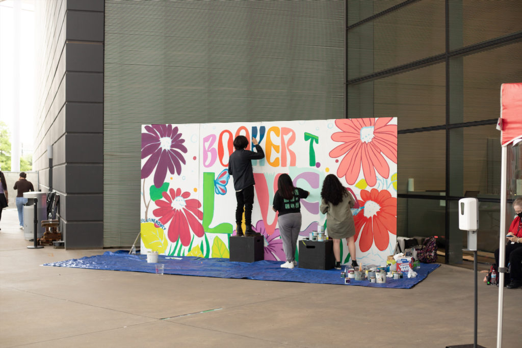 Booker T. Visual Arts students with a mural designed by Brooklynd Turner. 