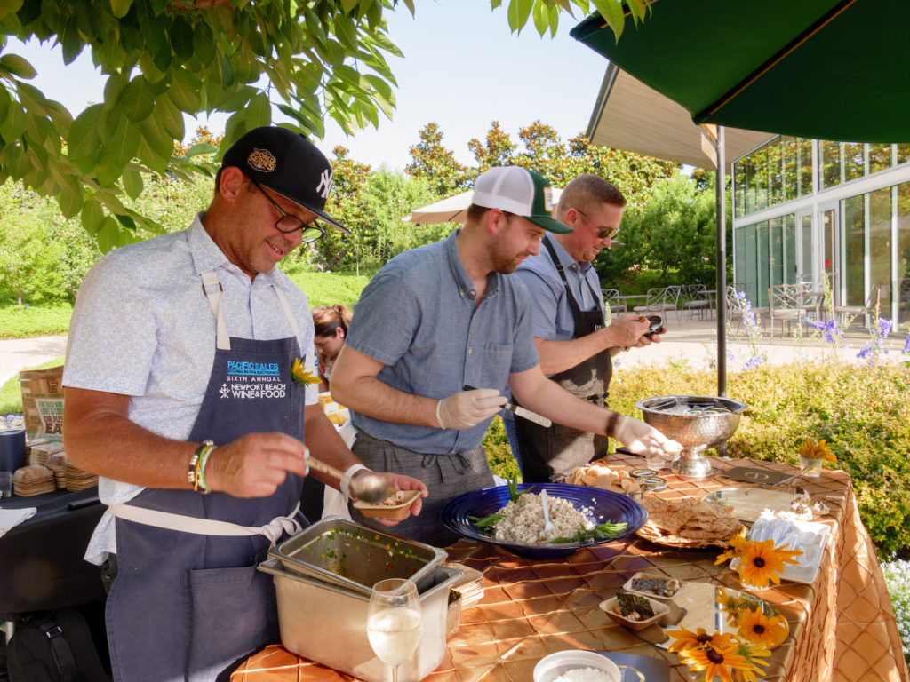 Chef John Tesar (left) prepares food for VIP guests in A Tasteful Place. (Photo by Dallas Arboretum/Steve Foxall)