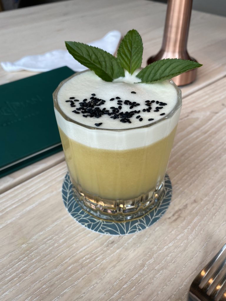 The Untitled, 1962 is a must-try cocktail with gin, egg white, and lime at Meridian. (Photo by Megan Ziots)