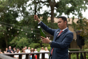 1.Houstonian Sommelier Dat Le sabers bubbly for the crowd (Photo by Daniel Ortiz)