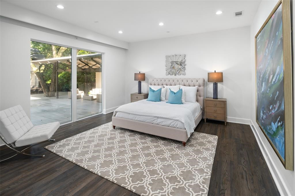 The master bedroom offers views of the lush backyard and leads out to an expansive deck. 