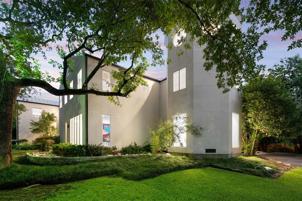 Lush landscaping contrasts with the clean-lined exterior. 