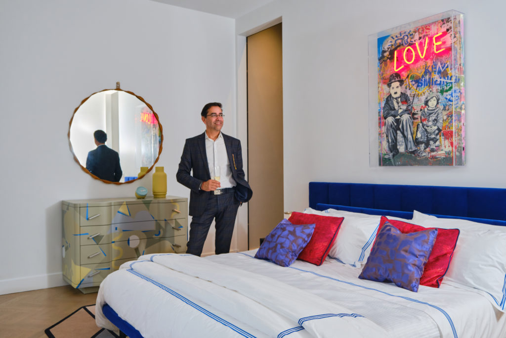 Marcelo Saenz studies one of the bedrooms in the Zanotta House in New York City during Adrian Dueñas' birthday celebration. (Photo by Malad Goyes @maladgoyes)