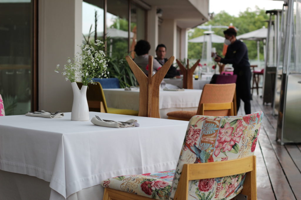 Guests engaging in conversation over a late lunch