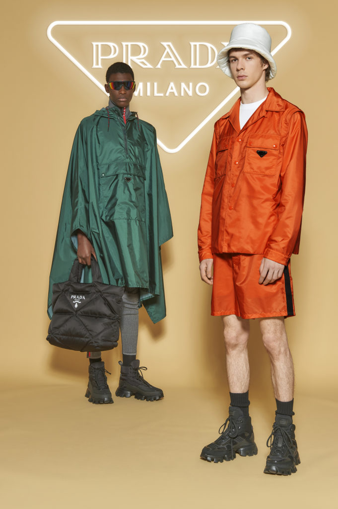 Left model: Prada nylon poncho, $1,610, pants price available upon request (not avail until October), sunglasses price available upon request, bag $1,590, shoes $1,170, Right model: Prada jacket $1,610, shorts $1,010, hat $595, shoes $1,170, most items available at the Prada Aspen boutique through September 7 (photo courtesy of Prada)