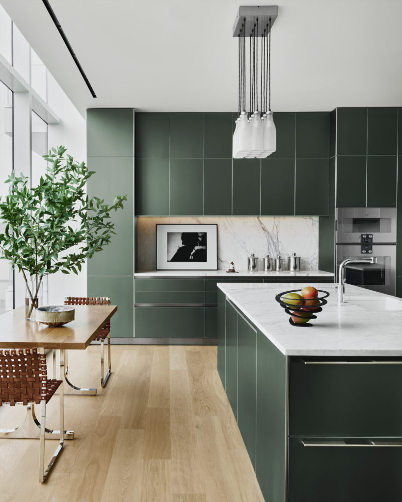 In the kitchen, Bulthaup aluminum cabinets. Droog chandelier. Custom table by Emily Summers Design Associates. Mark Albrecht Studio chairs. Kara Walker's Testimony Suite artwork. (Photo by Douglas Friedman)