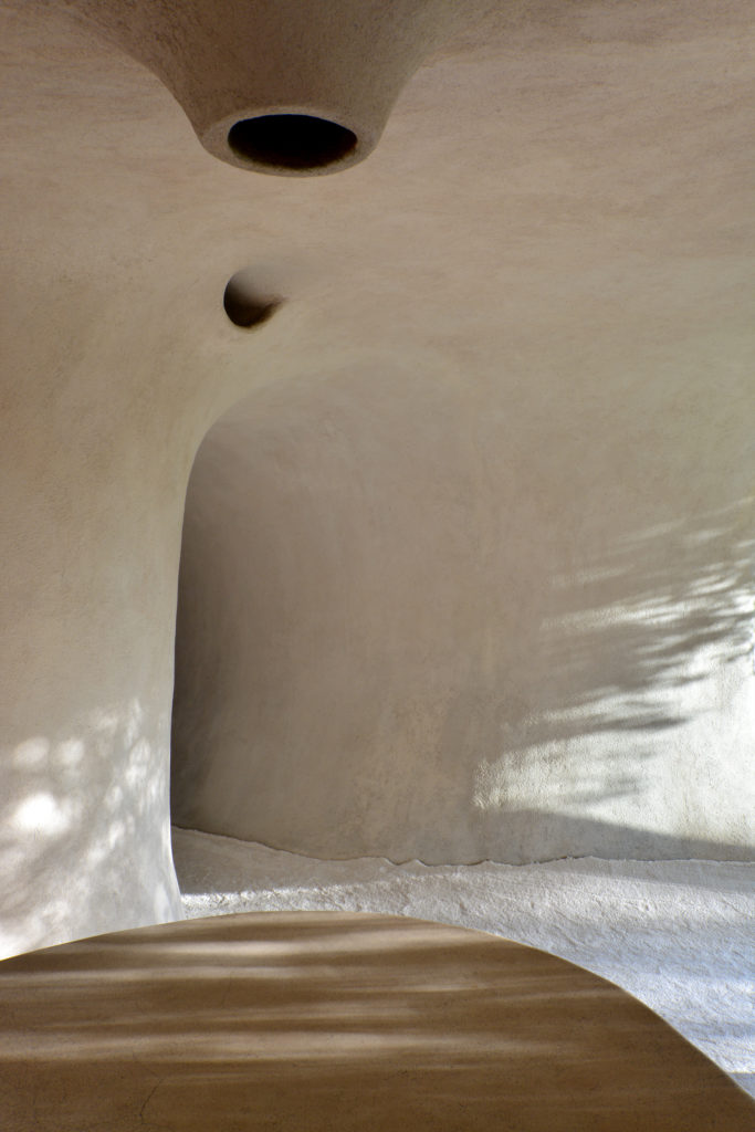 Darkened tunnels lead to light-filled spaces. (Photo by Pia Riverola and Arquitectura Orgánica)
