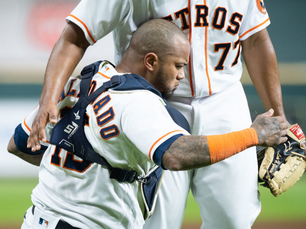 Martin Maldonado gave up his body to catch a foul ball in one of the defensive plays of the year. (Photo by F. Carter Smith)