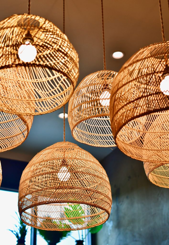 Woven rattan shaded lights hover above the bar at Casa Nomad. (Photo by Michael Anthony)
