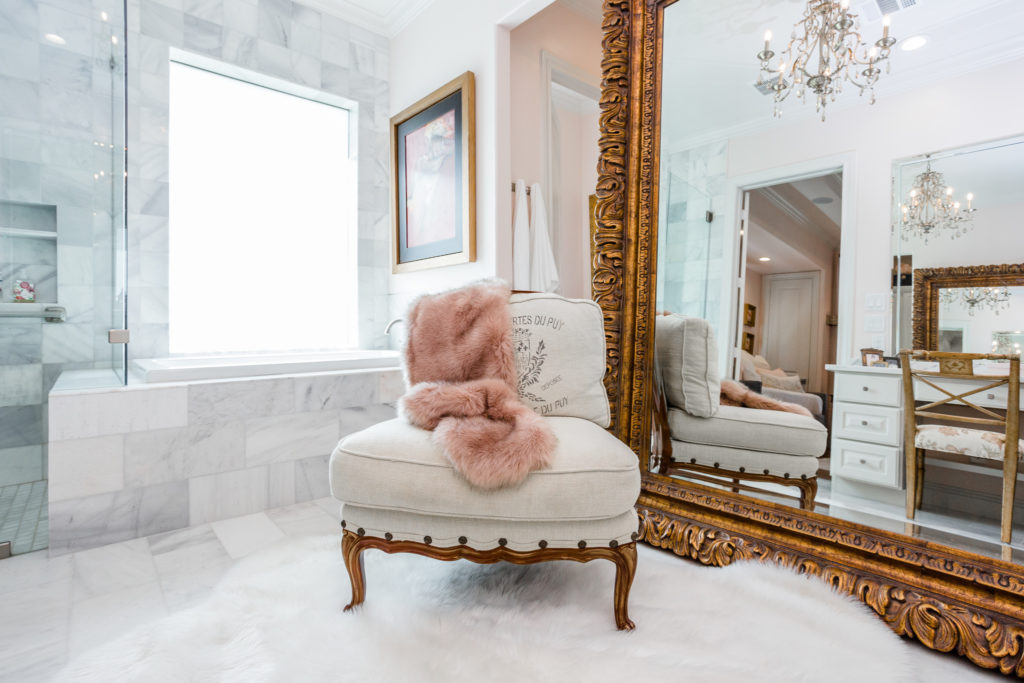 Marble, wood, stainless steel, and somewhere comforting to sit and reflect: This bathroom has all of that.