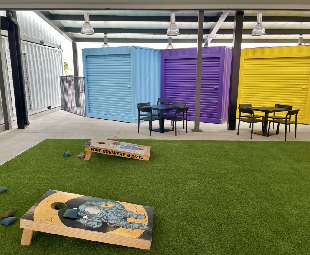 Cornhole court and patio seating at the new Fort Brewery on Tillar Street. Photo by Courtney Dabney.