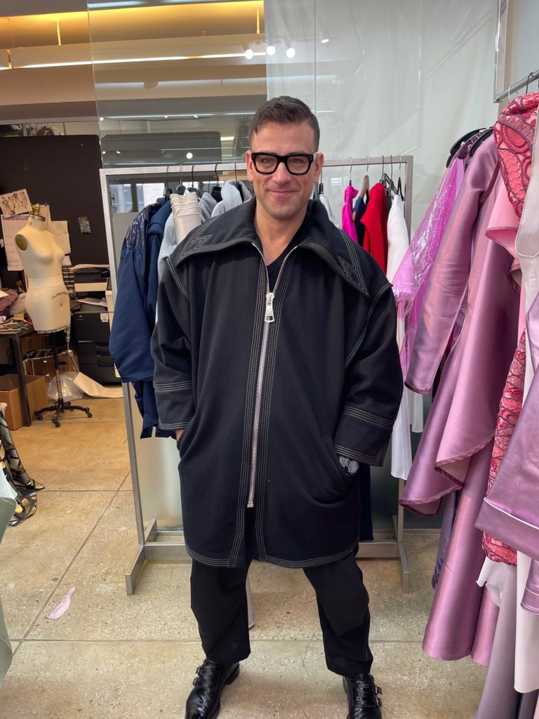 Rubin Singer models his new outerwear coat for men. (Photo by Clifford Pugh)