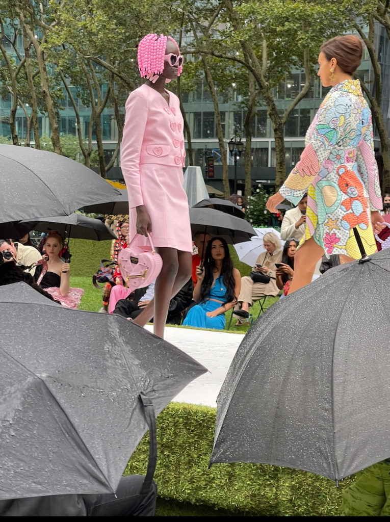 Moschino face-off: Models in pink two-piece skirt suit and cartoon coat. (Photo courtesy of Moschino)