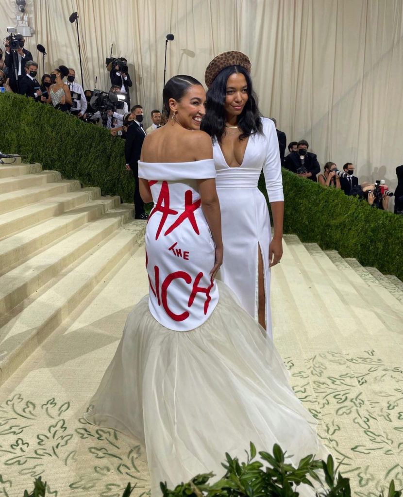 Alexandra Ocasio-Cortez wears a gown in "suffragette white" emblazoned with the phrase "Tax The Rich" (Instagram: @metmuseum)