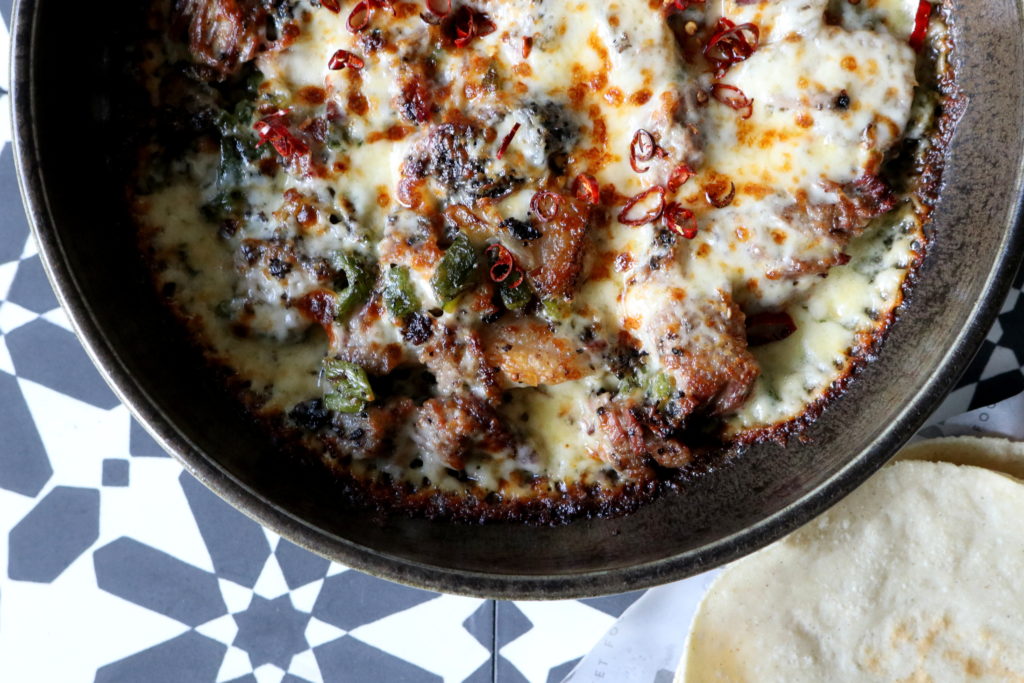 The queso flameado features charred brisket with melted chihuajua cheese studded with onion, peppers and mushrooms. (Photo by Paula Murphy)