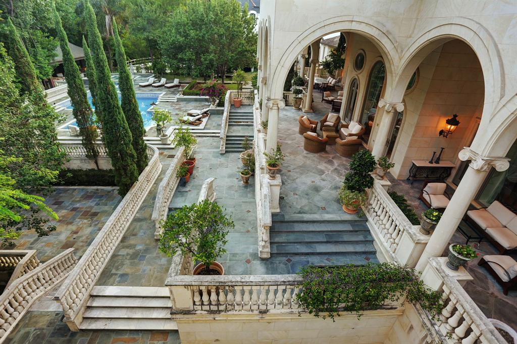 The pool and terrace at 8823 Harness Creek Lane reminds of a villa on the Cote d'Azur. 
