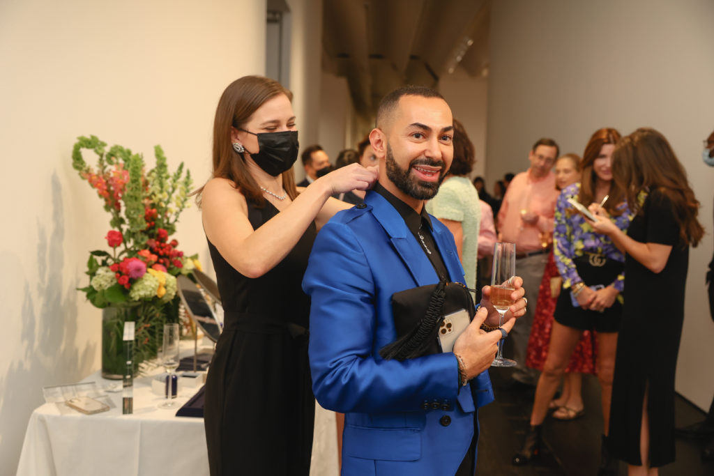 Fady Armanious trying on diamonds at the De Beers Jewellers celebration of its Reflections of Nature collection at The Menil Collection. (Photo by Johnny Than)