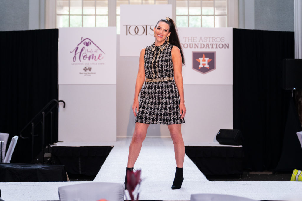 Liz Collins, the wife of coach Michael Collins, struck a pose on the runway.
