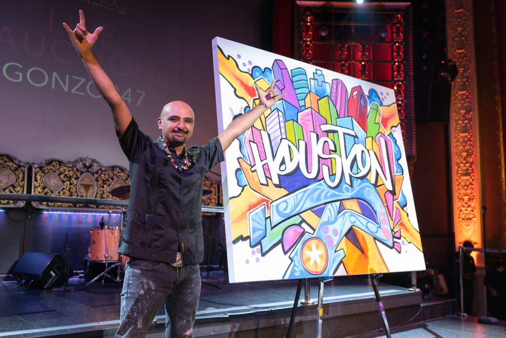 Gonzo and his artwork at the Houston Arts Alliance Moulin Rouge themed gala at the Majestic Metro theater. (Photo by Daniel Ortiz)