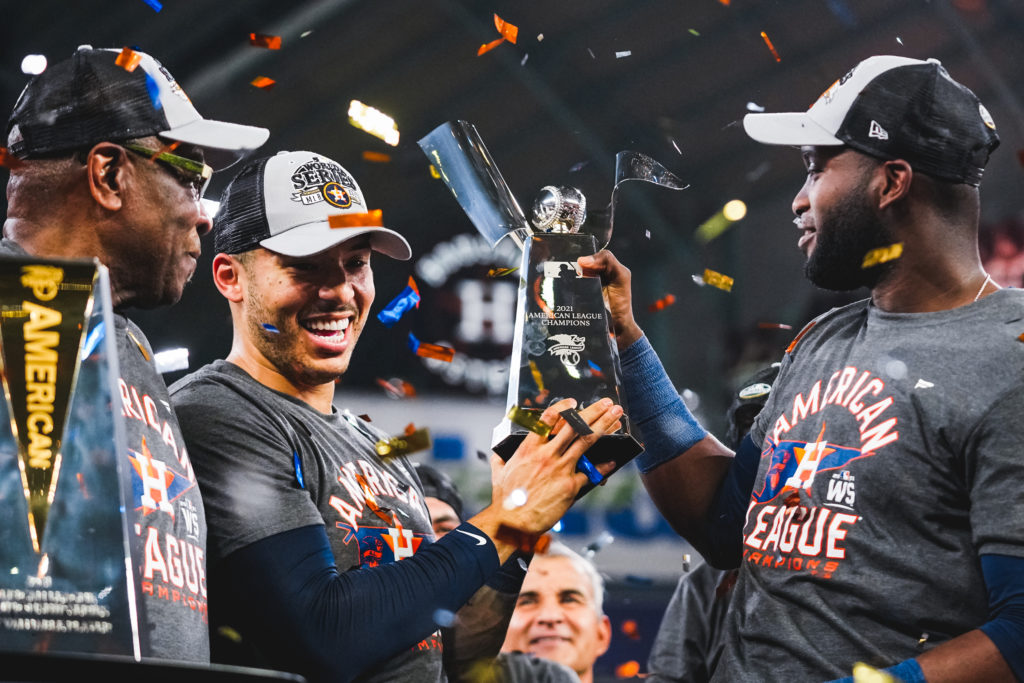 Yordan Alvarez takes a long look at ALCS MVP trophy as Dusty Baker and Carlos Correa look on. (@astros)