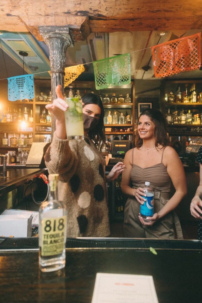 Kendall Jenner and Blayne Fertitta shake it up with Jenner's 818 Tequila at Tilman Fertitta's Dos Caminos in New York's Meatpacking District. (Photo by Sophie Sahara)
