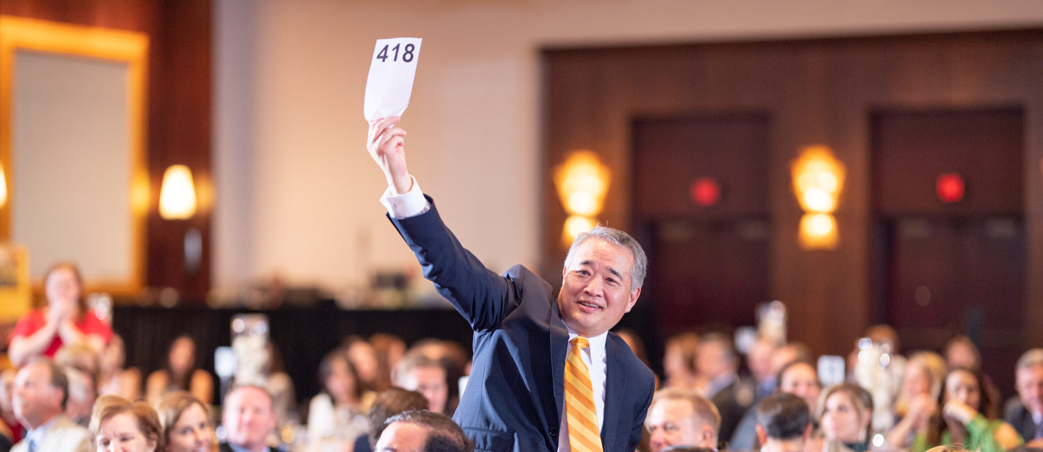 Cristo Rey Nicholas Ro generously participating in Paddles Up! (Photo by CatchLightGroup.com)