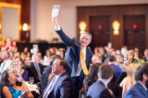 Cristo Rey Nicholas Ro generously participating in Paddles Up! (Photo by CatchLightGroup.com)