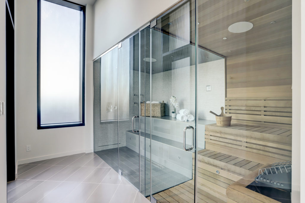 The master suite in The Astoria penthouse includes a sauna and steam room with built-in aromatherapy, cooling sprays, shower and speakers, Himalayan salt wall, and cedar paneling. (Photo by TK Images)