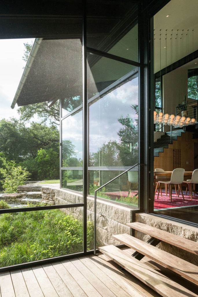 A giant screened porch connected to the main living room (and featuring a fireplace with ceramic balls) was the star of this stunning, Rollingwood home. (Photo by Tobin Davies Photography)