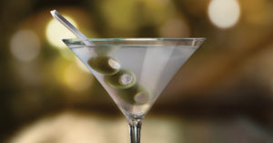 eddie v martini with three skewered blue cheese stuffed olives
